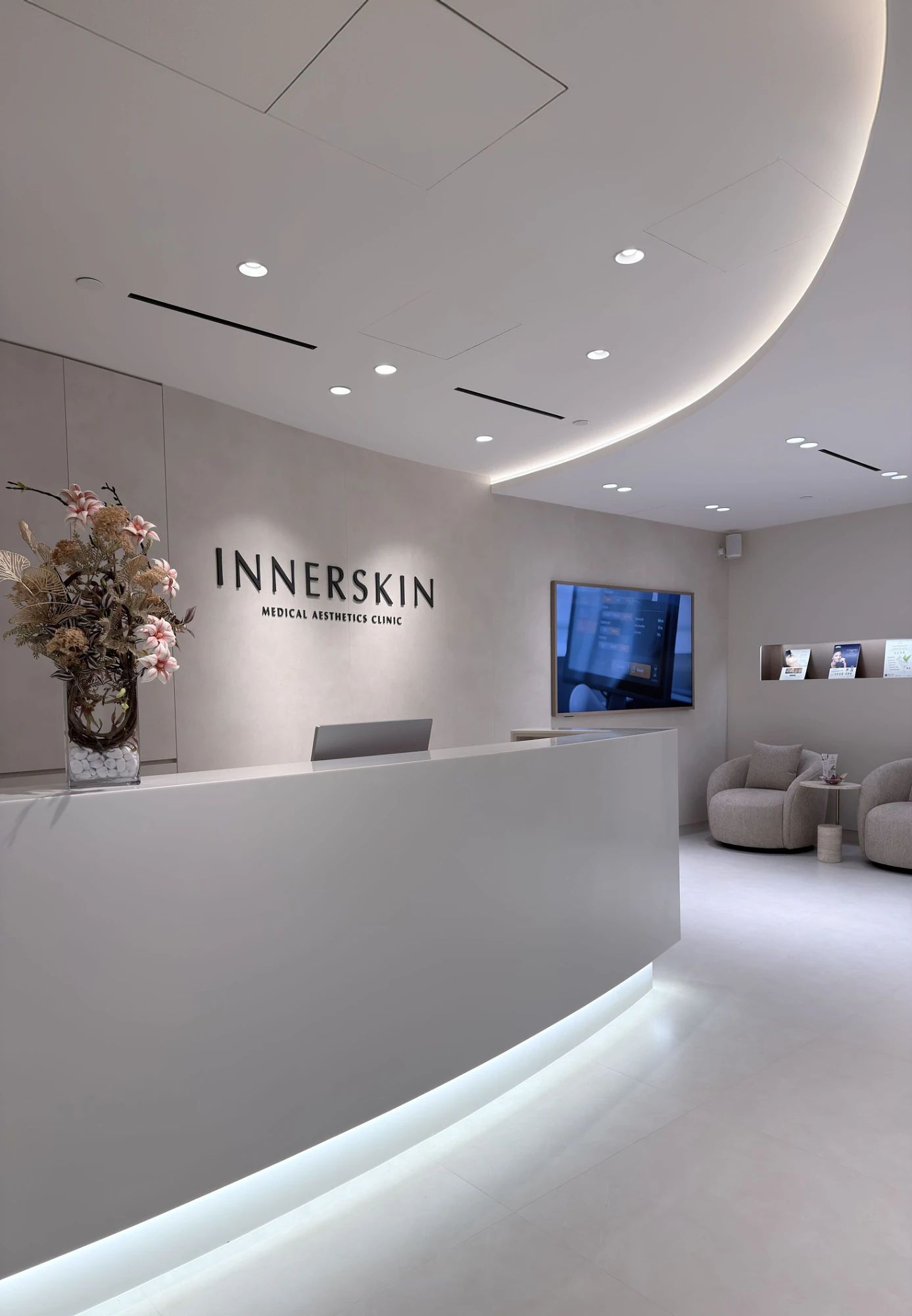 Curved reception counter and lounge at Innerskin Medical Aesthetics Clinic, Novena